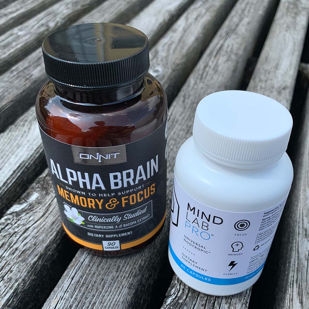 A bottle of Alpha Brain next to a bottle of Mind Lab Pro - Which nootropic is better?