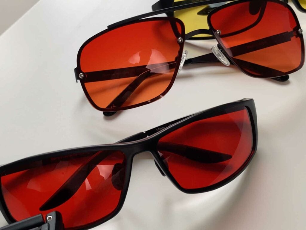 Two TrueDark glasses with red lenses