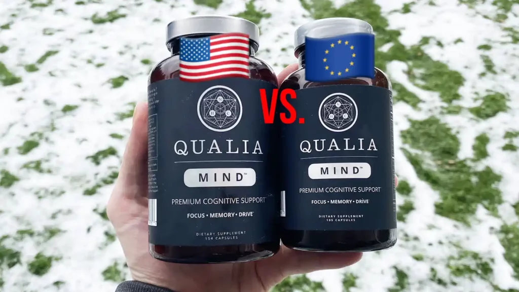 A hand holding one bottle of Qualia Mind US and one bottle of Qualia Mind EU