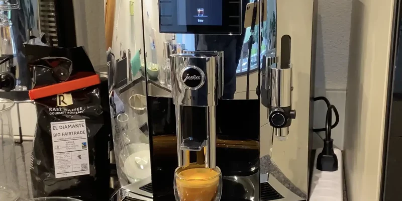 The Jura E8 in chrome coffee machine brewing an espresso