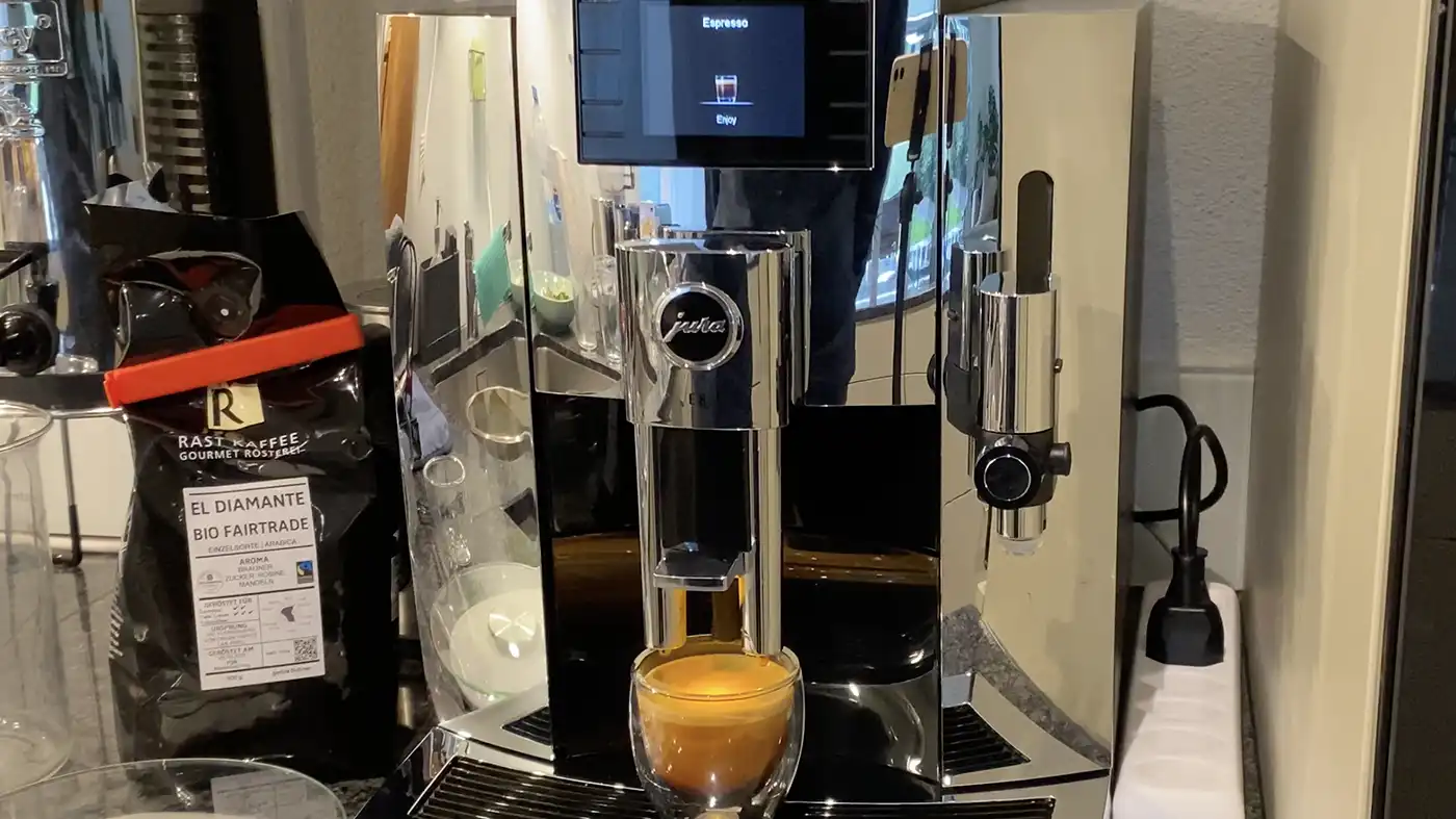 The Jura E8 in chrome coffee machine brewing an espresso