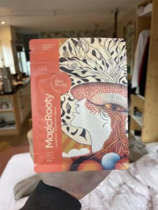 My hand holding a pack of FeelRooty MagicRooty